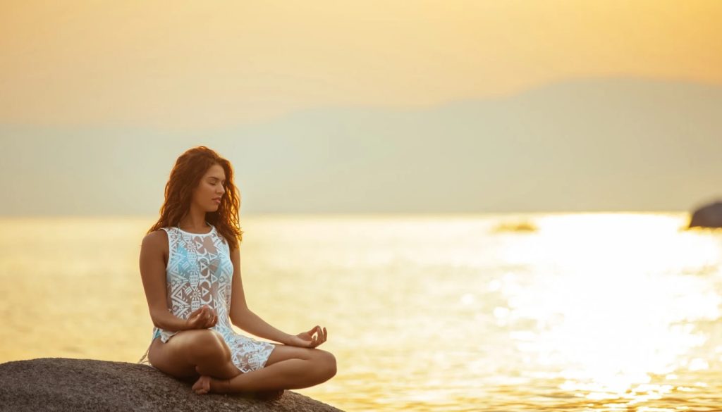 Photo of a woman sitting in yoga lotus position, depicting the wellness therapy services offered at wave counselling and wellness in st. John's newfoundland and labrador.