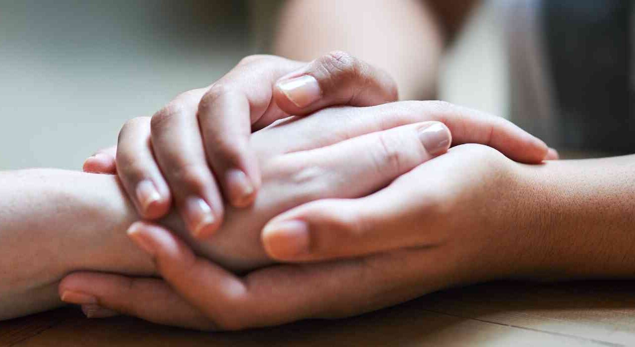 Photo Of A Pair Of Hands Encircling A Single Hand Depicting The Anxiety Therapy Services Offered At Wave Counselling And Wellness In St John's NL.